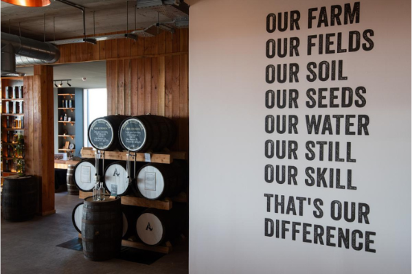 Whisky barrels at Arbikie Distillery surrounded by a quote which says our farm, our fields, our soil, our seeds, our water, our still, our skill, that's our difference.