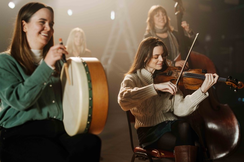 A group of six musicians playing instruments