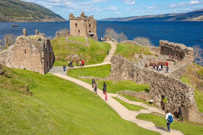 The medieval fortress of Urquhart Castle surrounded by water and hills